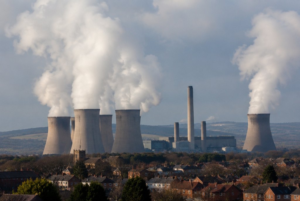 coal power station cooling towers emitting plumes over a town coal power station cooling towers emitting plumes over a town